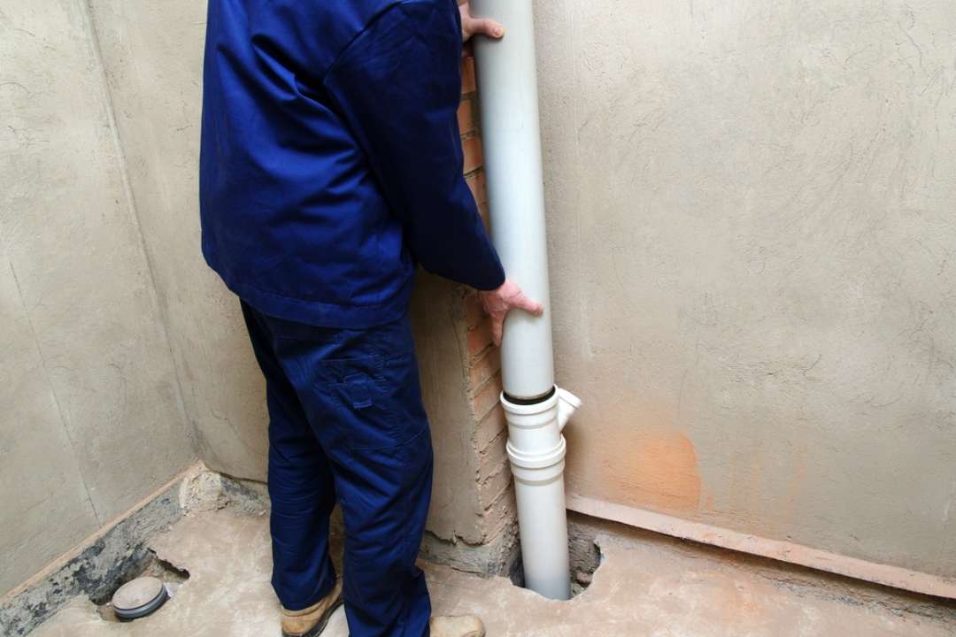 A member of our Caloundra plumbing team fixing a pipe