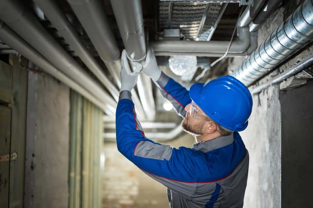 Commercial Plumber Inspecting Pipes